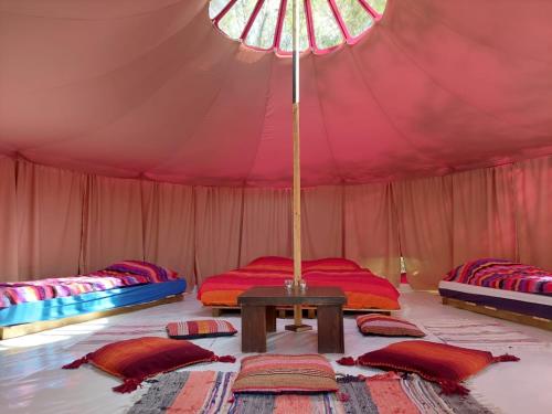 a tent with two beds and a table in it at CampSpirit in Biddinghuizen