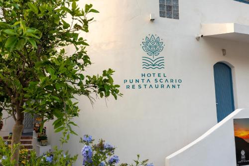 a sign for a hotel on the side of a building at Hotel Punta Scario in Malfa