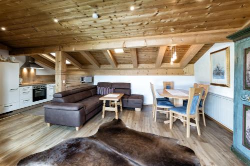 a living room with a couch and a table at Appartementanlage Kerber in Seefeld in Tirol