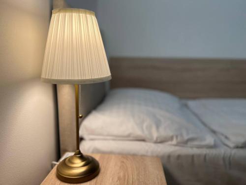a lamp sitting on a table next to a bed at Hotel Garden Court in Prague