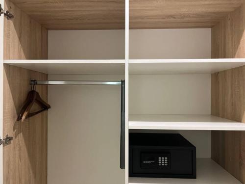 a walk in closet with a cupboard with a microwave at Hotel Garden Court in Prague