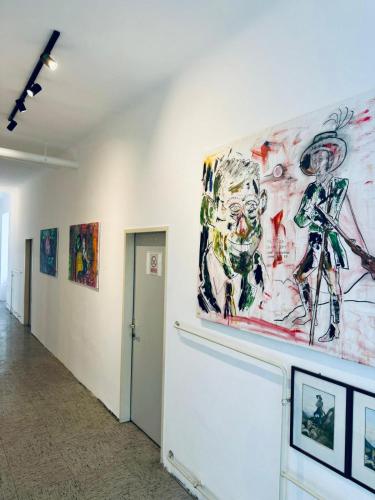 a painting on the wall of a room with paintings at NUMBR25 - self service & low budget Hotel in Graz