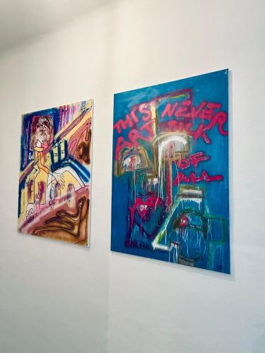 two paintings of a train on a wall at NUMBR25 - self service & low budget Hotel in Graz