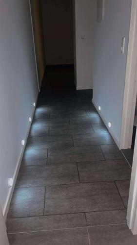 a hallway with a tile floor with lights on it at Cozy New Apartment in Vejle City Center in Vejle