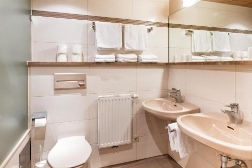 a white bathroom with a toilet and a sink at Appartementanlage Kerber in Seefeld in Tirol