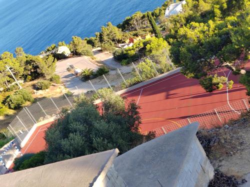 an aerial view of a tennis court next to the water at Karla in Sveta Nedelja