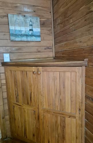 a wooden cabin with a wooden wall at Linga Bay Retreat in Morrumbene