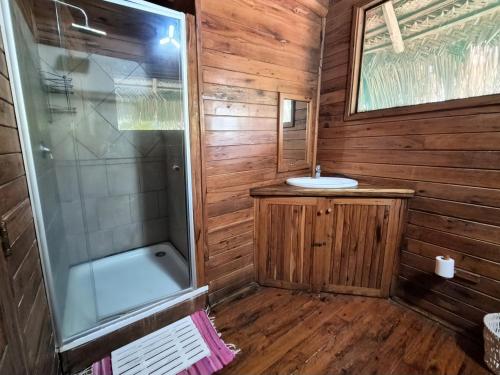 a bathroom with a shower and a sink at Linga Bay Retreat in Morrumbene