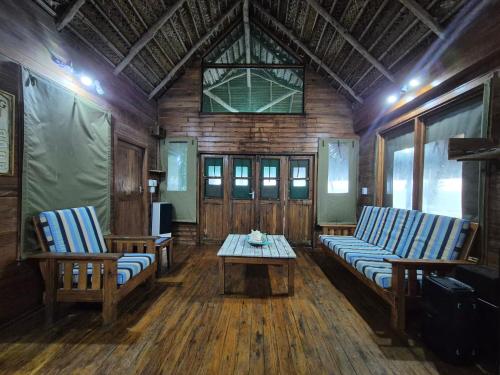 a living room with two chairs and a coffee table at Linga Bay Retreat in Morrumbene