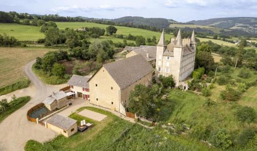 an aerial view of a large house with a church at Gite le crespin in Antrenas