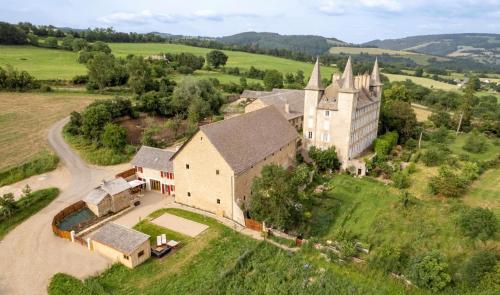 an aerial view of a large house with a church at Gite le crespin in Antrenas
