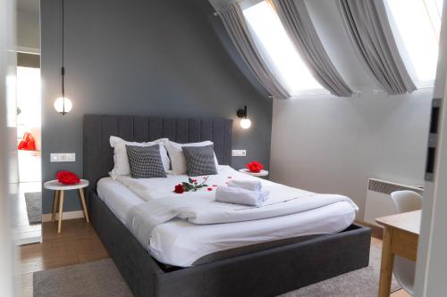 a bedroom with a large bed with red roses on it at "The House" Апартаменти и Термална зона in Velingrad