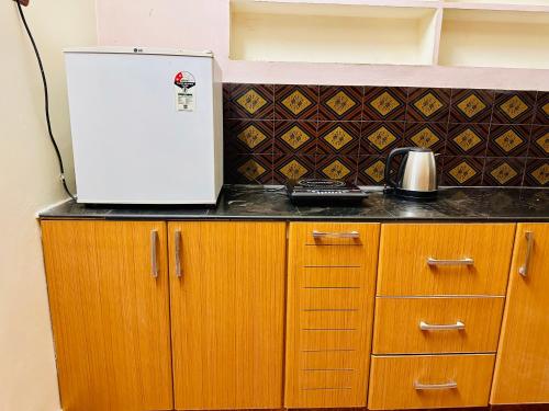 a refrigerator sitting on top of a kitchen counter at Divine Homestay by EDAC in Chidambaram
