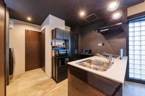 a kitchen with a sink and a microwave at Taiho Square 7th floor - Vacation STAY 19139 in Osaka