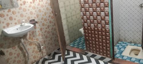a bathroom with a sink and a toilet at Little KANHA ji PG 10 Room82798s58346 Hotal, also taxi and Activa rent in Mathura