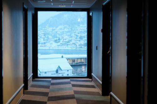 a hallway with a view of a city from a window at Comfort Hotel Xpress Tromsø in Tromsø