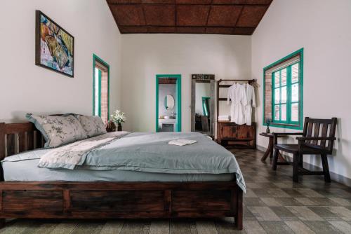 a bedroom with a bed and a desk and a chair at Lamer Coastal Villa in Hoi An