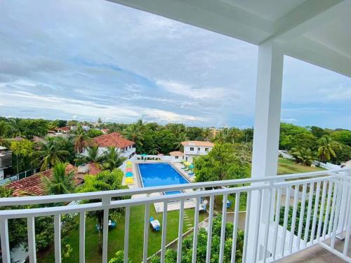 a balcony with a view of a swimming pool at La Casablanca Tourist Hotel Negombo in Negombo