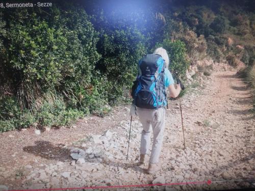 a person with a backpack walking down a dirt trail at Sezze - Casa tra mare e monti di Luigi & Fabiana in Sezze