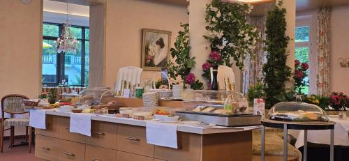 a buffet line with food on display in a restaurant at Hotel Alpina in Bad Reichenhall