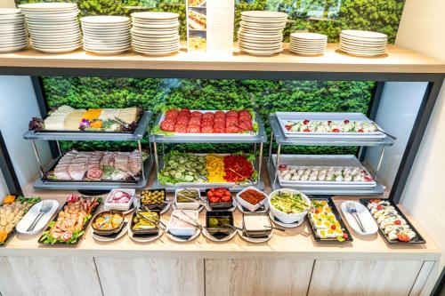 a display case filled with different types of food at Czarny Kamień Resort & SPA in Szklarska Poręba