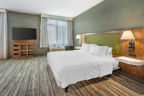 a hotel room with a large bed and a flat screen tv at Hampton Inn and Suites Coeur d'Alene in Coeur d'Alene