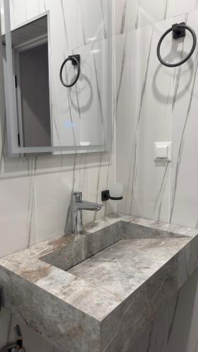 a bathroom with a sink and a mirror at MARCO Hotel in Goris