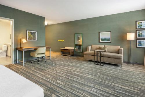 a living room with a couch and a desk at Hampton Inn and Suites Coeur d'Alene in Coeur d'Alene