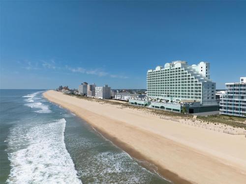 a view of a beach with buildings and the ocean at Hilton Suites Ocean City Oceanfront in Ocean City
