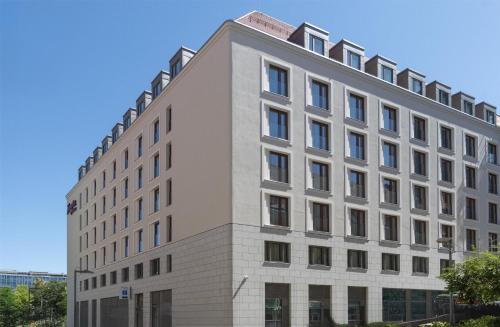 a large white building with windows at Hampton By Hilton Dresden City Centre in Dresden