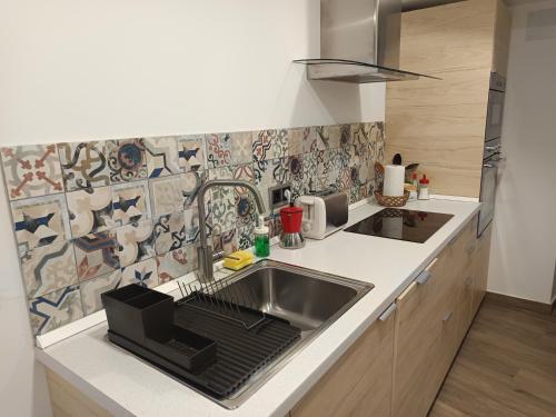 a kitchen with a sink and a counter top at El Apartamento de Hervás in Hervás