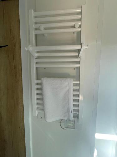 an open refrigerator with a white towel in it at Camping Du Perche Bellemois in Bellême