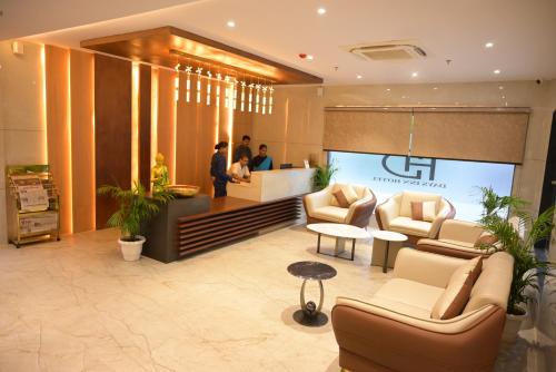 a lobby with couches and people in a store at Hotel dayss Inn in Varanasi