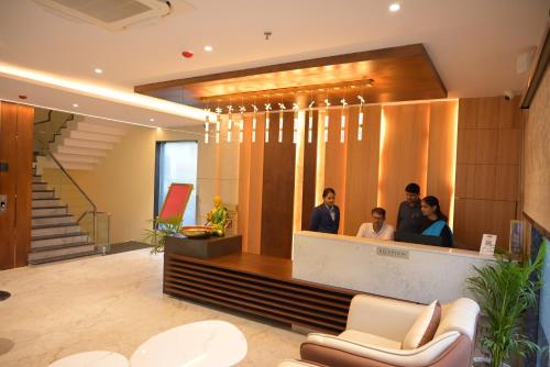 a group of people in a lobby at Hotel dayss Inn in Varanasi