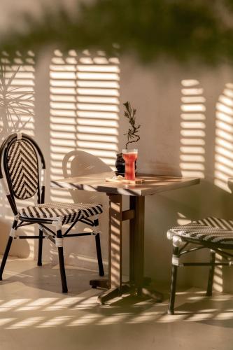 a table and two chairs and a table with a drink on it at M ORIGINAL VILLA in Jinghong