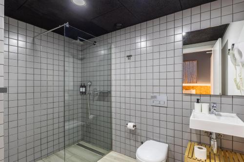 a bathroom with a shower and a toilet and a sink at Brick Palma - Turismo de Interior in Palma de Mallorca