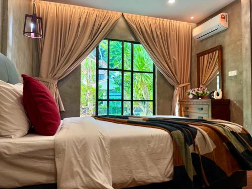 a bedroom with a bed with a large window at Sunway Lakeside Bungalow in Ipoh in Ipoh