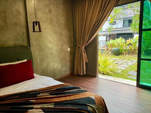 a bedroom with a bed and a large window at Sunway Lakeside Bungalow in Ipoh in Ipoh