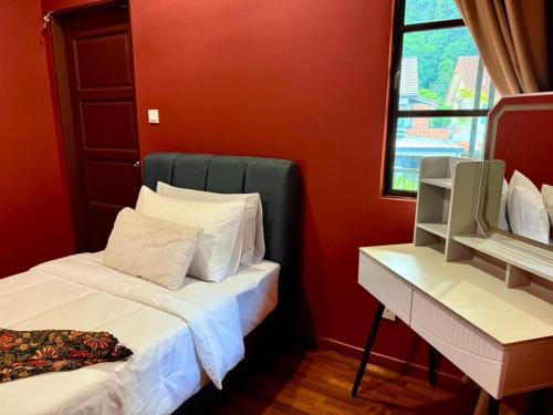 a red room with two beds and a window at Sunway Lakeside Bungalow in Ipoh in Ipoh