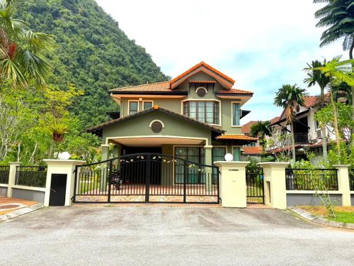 a house with a gate in front of it at Sunway Lakeside Bungalow in Ipoh in Ipoh