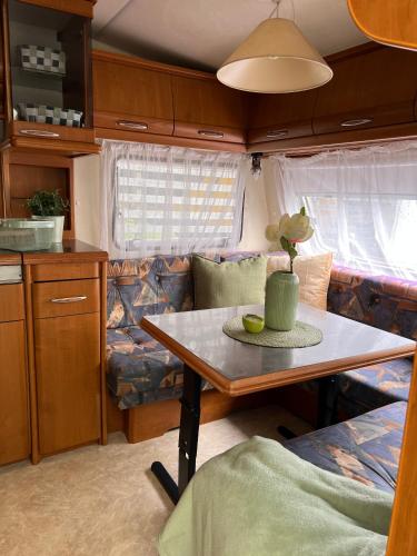 a small kitchen with a table in a caravan at Highway to Hel in Jastarnia