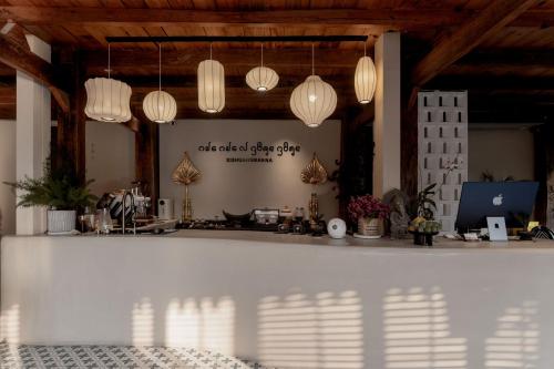 a room with a white counter with lights at M ORIGINAL VILLA in Jinghong