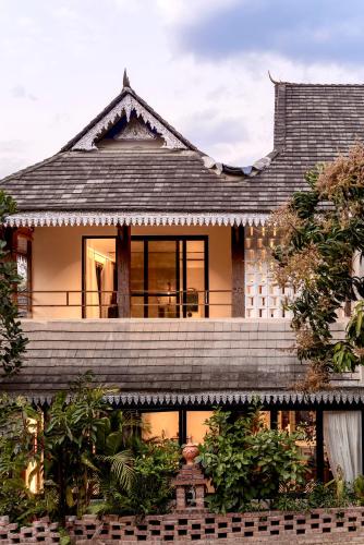 a house with a shingled roof at M ORIGINAL VILLA in Jinghong