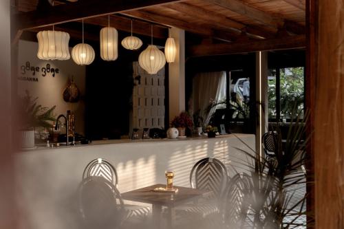 a kitchen with a table and chairs and lights at M ORIGINAL VILLA in Jinghong