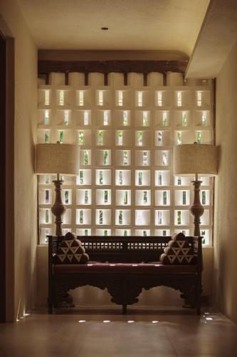 a window in a room with a bench in front at M ORIGINAL VILLA in Jinghong