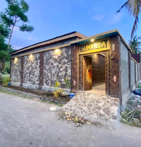a building with a sign that reads sunmillilla at Namali Villa Gili Trawangan in Gili Trawangan