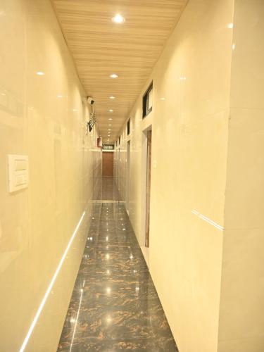a hallway with a tile floor in a building at Hotel Royal BKC in Mumbai