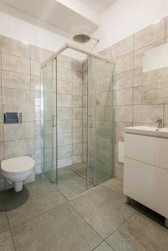 a bathroom with a shower and a toilet and a sink at StarBal in Radom