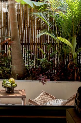 a room with a table and some plants and a fence at M ORIGINAL VILLA in Jinghong