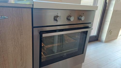 an oven in a kitchen with its door open at Profumo di Zagara Acireale in Acireale